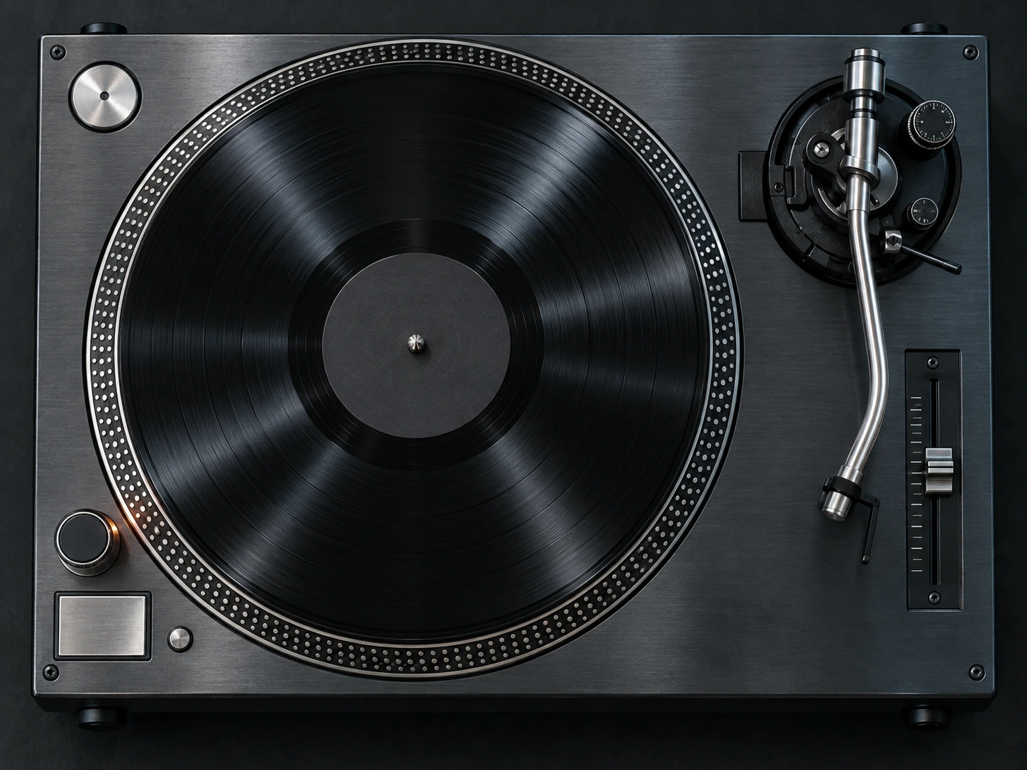 A brushed-metal direct-drive record player with black vinyl, a silver tonearm and a pitch fader.